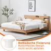 A bedroom scene with a wooden bed and bedding, featuring a close-up inset of a white product. Produktbild-Vorschau
