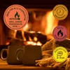 Two mugs of hot drinks in front of a fireplace, with marketing badges overlaid. Produktbild-Vorschau