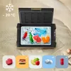 An open electric cooler filled with ice, drinks, and popsicles, placed on a sandy beach. Anteprima dell’immagine prodotto