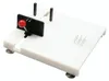 A white cutting board with suction cups and a red knobbed adjustable stopper. Produktbild-Vorschau