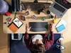 A person is working at a desk with a laptop, monitor, keyboard, and other accessories. Anteprima dell’immagine prodotto