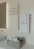 A modern bathroom setting with a heated towel rack and a basket of towels. Náhľad obrázku produktu