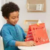 A young boy is playing a board game at a table. Anteprima dell’immagine prodotto