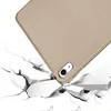 A close-up shot of a tan tablet case falling and hitting a surface that is breaking apart. Produktbild-Vorschau
