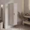 A modern bathroom with a tall, ribbed cabinet, towels on a rack, and decorative dried grass in a vase. Produktbild-Vorschau