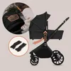 A collage showing a black stroller with a bassinet, a close-up of a person adjusting the stroller, and a pair of stroller adapters. Voir les images du produit