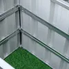 Close-up view of the corner of a raised garden bed, showing the metal frame and the green artificial grass inside. Podgląd zdjęcia produktu