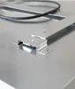 A close-up view of a metal surface with a black cable and metal brackets. Produktbild-Vorschau