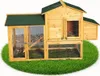 A wooden chicken coop with a green roof, situated on a circular patch of green grass. Podgląd zdjęcia produktu