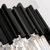 A close-up view of a black and clear chandelier. Produktbild-Vorschau