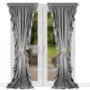 Two gray velvet curtains with ruffles are shown hanging in front of a window.