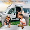 A couple is sitting at a camping table in front of a camper van, enjoying a meal outdoors. Produktbild-Vorschau