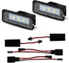 Two LED license plate lights and their wiring harnesses are displayed against a white background. Anteprima dell’immagine prodotto