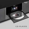 A close-up shot of a black and silver CD player with a CD partially inserted and a small screen displaying icons. Voir les images du produit