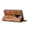 A brown flip case for a smartphone is shown from the side, propped open. Produktbild-Vorschau