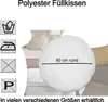 A round white pillow is shown on a bed with other pillows and bedding. Care instructions and size information are displayed. Produktbild-Vorschau