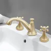 A close-up shot of a gold-colored faucet set on a white sink. Podgląd zdjęcia produktu