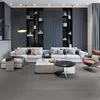 A modern living room with a sectional sofa, coffee tables, and built-in shelving. Produktbild-Vorschau
