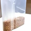 A close-up shot of a clear plastic food storage container filled with buckwheat. Produktbild-Vorschau