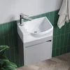A small, corner-mounted sink with a modern faucet is shown in a bathroom setting with green tiled walls and a wooden floor. Produktbild-Vorschau