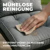 A hand is wiping a stain off a gray outdoor cushion with a cloth. Produktbild-Vorschau