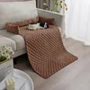 A dog bed cover is placed on a sofa, with a stuffed dog on top. Náhled obrázku produktu