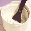 A close-up shot of a rice cooker with a spatula inside, filled with rice. Produktbild-Vorschau