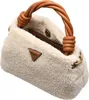 A close-up shot of a fluffy beige handbag with a braided brown handle. Produktbild-Vorschau