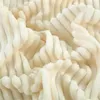 A close-up view of a soft, textured blanket with a ribbed pattern. Podgląd zdjęcia produktu
