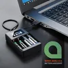 A battery charger connected to a laptop, with batteries inside the charger. Anteprima dell’immagine prodotto