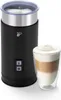 A black electric milk frother with a glass of latte macchiato next to it. Produktbild-Vorschau