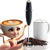 A coffee frother with a cup of coffee and a mug filled with frothy coffee. Náhled obrázku produktu