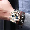A man's wrist wearing a watch and a bracelet, with a suit jacket in the background. Produktbild-Vorschau