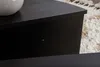 A close-up view of a black wooden furniture piece, possibly a table or cabinet, with a textured white object on top. Produktbild-Vorschau