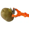 A potato is being peeled with an orange peeler. Voir les images du produit