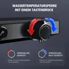 Close-up of a black shower faucet with temperature control dial and instructional graphics. Náhľad obrázku produktu