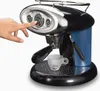 A hand is pressing a button on a black and blue espresso machine with chrome accents. A small espresso cup is placed on the drip tray. Podgląd zdjęcia produktu