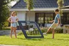 Two children are playing soccer in a backyard with a soccer rebounder. Podgląd zdjęcia produktu