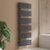 A modern anthracite radiator is mounted on a light brown wall next to a bathtub and shower enclosure. Podgląd zdjęcia produktu