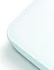 A close-up of the corner of a white product with a light blue edge. Podgląd zdjęcia produktu