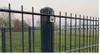 A close-up view of a metal fence with a lock on one of the posts. Produktbild-Vorschau