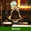 A close-up of a bell-shaped LED light decoration hanging in a window, with measurements indicated. Produktbild-Vorschau