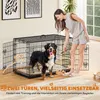 A woman is interacting with a dog inside a dog crate in a living room setting. Produktbild-Vorschau