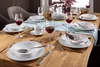A dining table set for a meal with tableware and wine glasses. Produktbild-Vorschau