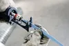 A close-up shot of a person's gloved hands attaching a reciprocating saw blade to a reciprocating saw. Voir les images du produit