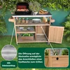 A wooden grill station with a stainless steel top, set up outdoors on a lawn with greenery in the background. Produktbild-Vorschau