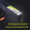 A close-up shot of a black capacitor discharge pen with a yellow and white label, set against a dark background with glowing orange elements and small sparks. Produktbild-Vorschau
