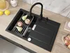 A black granite sink with a black faucet and a drying rack with fruit. Produktbild-Vorschau