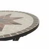 A close-up view of the edge of a round mosaic table with a star pattern. Produktbild-Vorschau