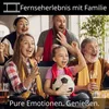 A family is watching TV and cheering, with a soccer ball in the foreground. Produktbild-Vorschau